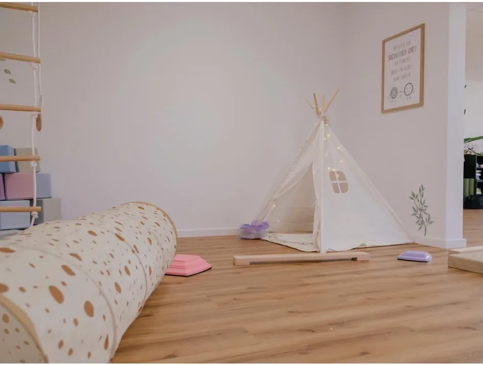 Pädiatrischer Ergotherapieraum mit Spielzelt und Bewegungslandschaft