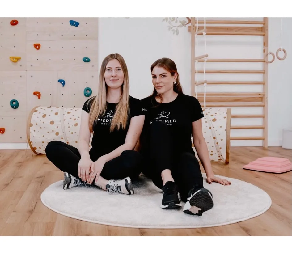 Zwei Therapeutinnen von Riedimed im hellen Ergotherapieraum